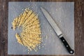 ChefÃ¢â¬â¢s knife and a pile of chopped raw walnuts on a plastic cutting mat, ready for baking Royalty Free Stock Photo